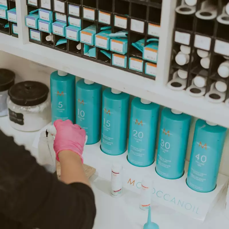 This is an image of a girl mixing Moroccan Oil products.